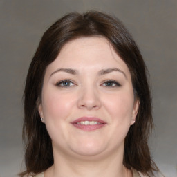 Joyful white young-adult female with medium  brown hair and brown eyes