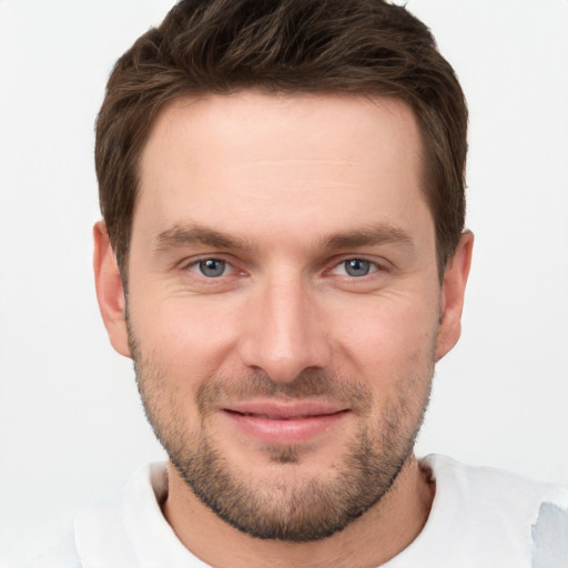 Joyful white young-adult male with short  brown hair and grey eyes