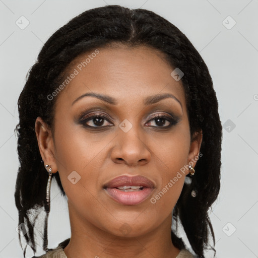 Joyful black young-adult female with long  brown hair and brown eyes