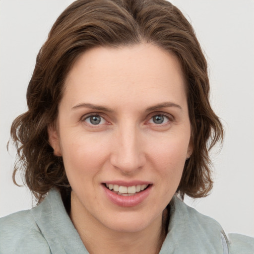 Joyful white young-adult female with medium  brown hair and green eyes