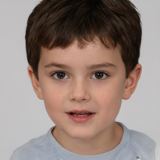 Joyful white child male with short  brown hair and brown eyes