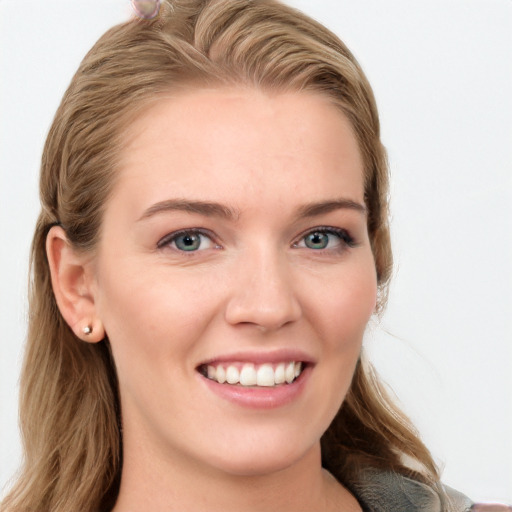 Joyful white young-adult female with long  brown hair and blue eyes