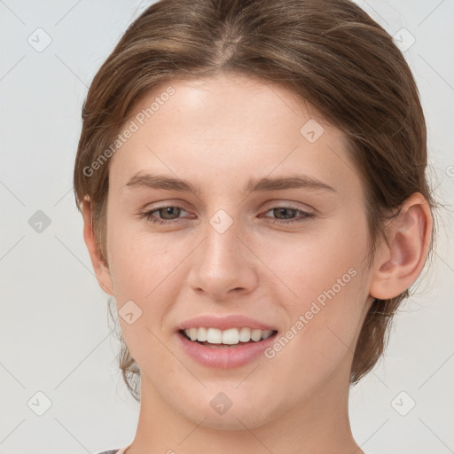 Joyful white young-adult female with medium  brown hair and grey eyes