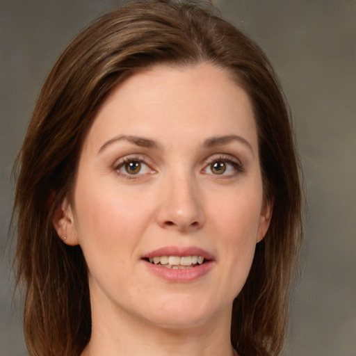 Joyful white young-adult female with medium  brown hair and green eyes