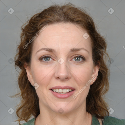 Joyful white adult female with medium  brown hair and blue eyes