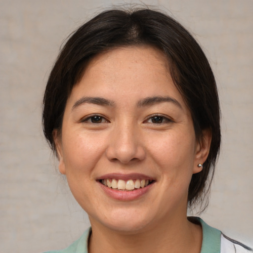 Joyful asian young-adult female with medium  brown hair and brown eyes