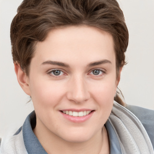 Joyful white young-adult female with short  brown hair and grey eyes