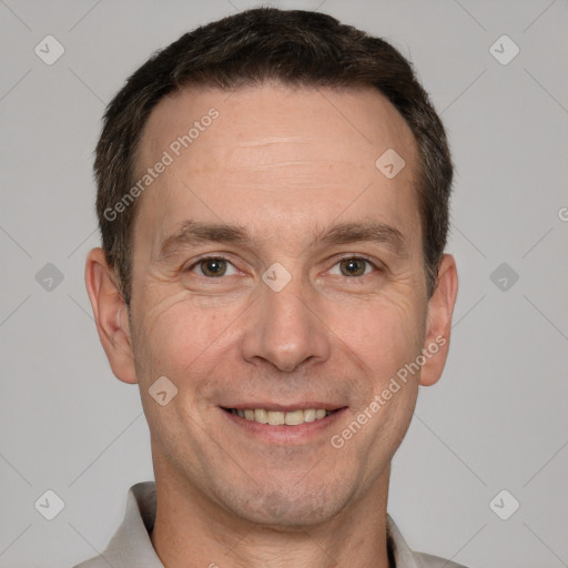 Joyful white adult male with short  brown hair and brown eyes