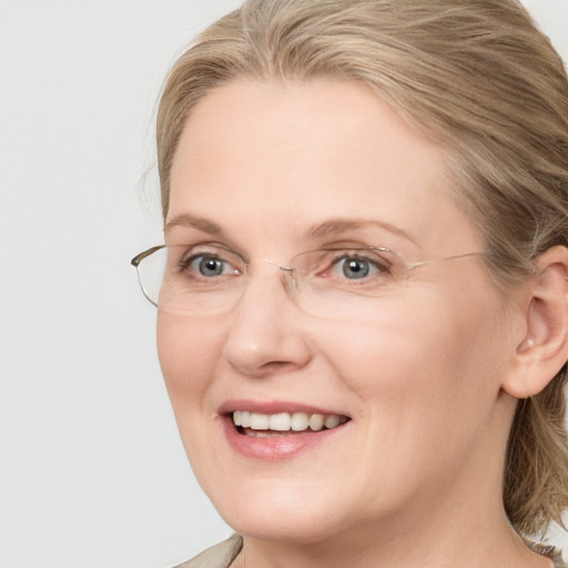 Joyful white adult female with medium  brown hair and blue eyes