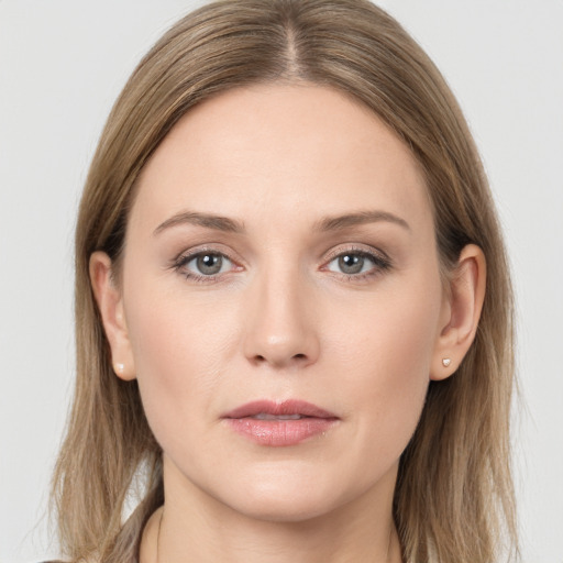 Joyful white young-adult female with long  brown hair and grey eyes