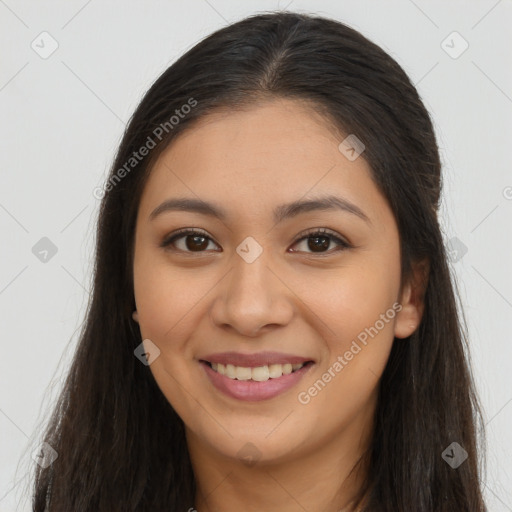 Joyful latino young-adult female with long  brown hair and brown eyes