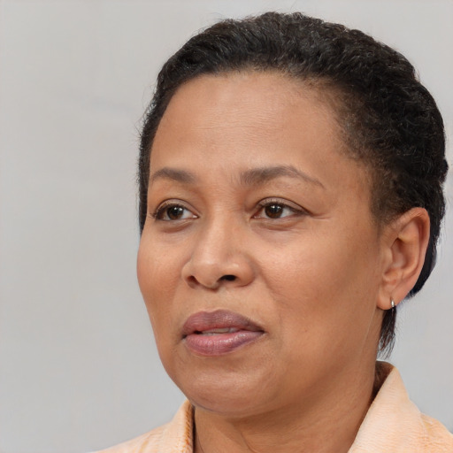 Joyful black adult female with short  brown hair and brown eyes