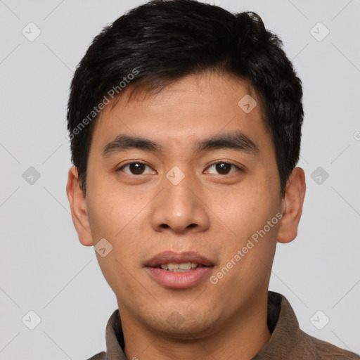 Joyful asian young-adult male with short  black hair and brown eyes