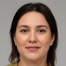 Joyful white young-adult female with medium  brown hair and brown eyes