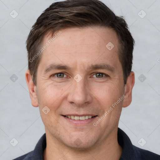 Joyful white adult male with short  brown hair and brown eyes