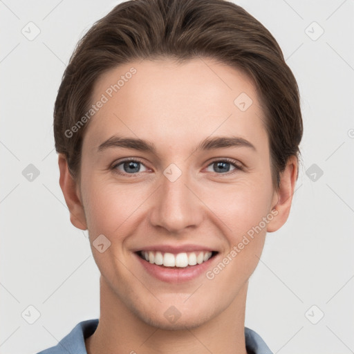 Joyful white young-adult female with short  brown hair and grey eyes