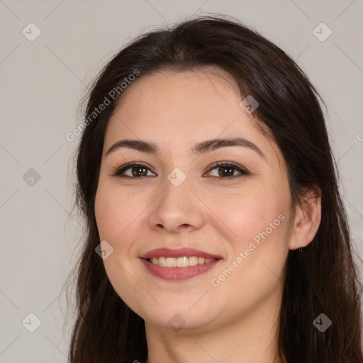 Joyful white young-adult female with long  brown hair and brown eyes