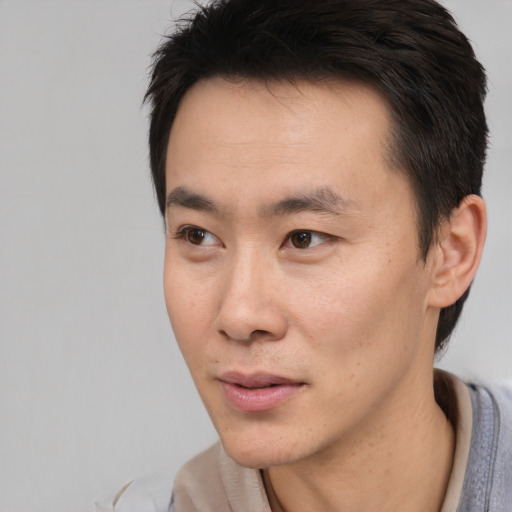 Neutral asian young-adult male with short  black hair and brown eyes
