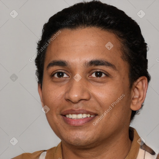 Joyful latino young-adult male with short  black hair and brown eyes
