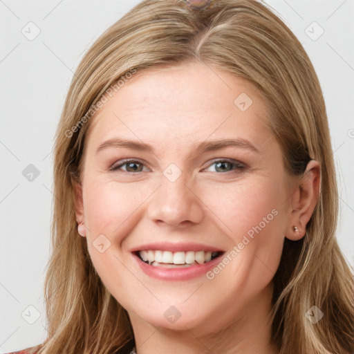 Joyful white young-adult female with long  brown hair and blue eyes