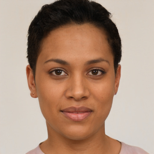 Joyful latino young-adult female with short  black hair and brown eyes