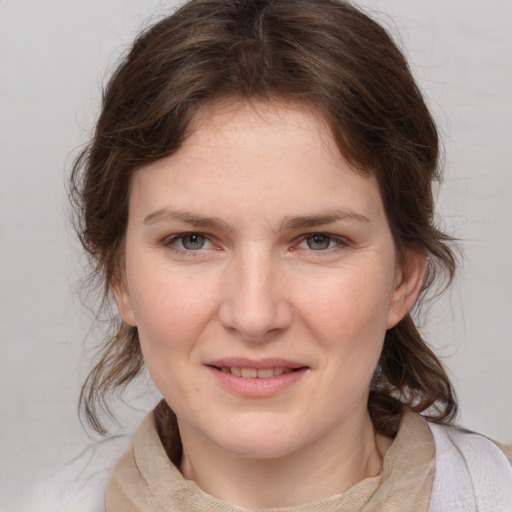 Joyful white young-adult female with medium  brown hair and blue eyes