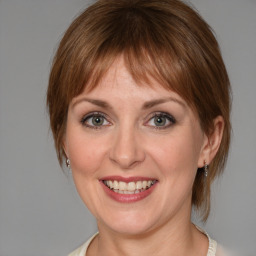 Joyful white young-adult female with medium  brown hair and blue eyes