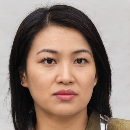 Joyful asian young-adult female with medium  brown hair and brown eyes