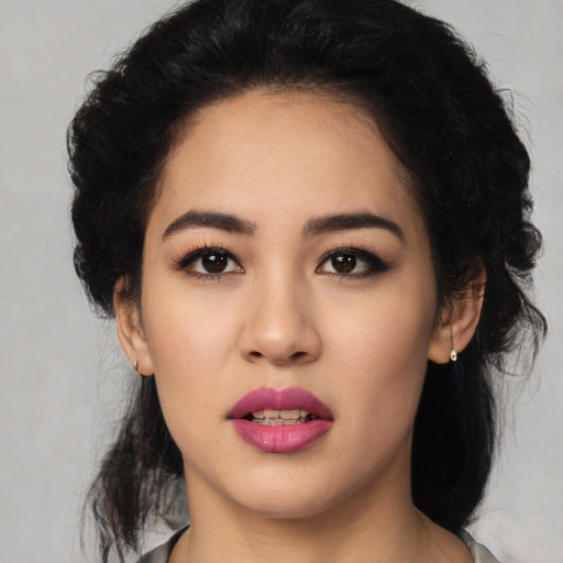 Joyful latino young-adult female with medium  black hair and brown eyes