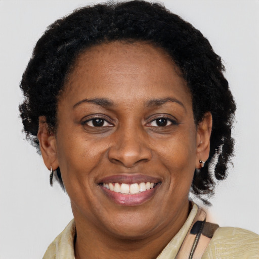 Joyful black adult female with short  brown hair and brown eyes