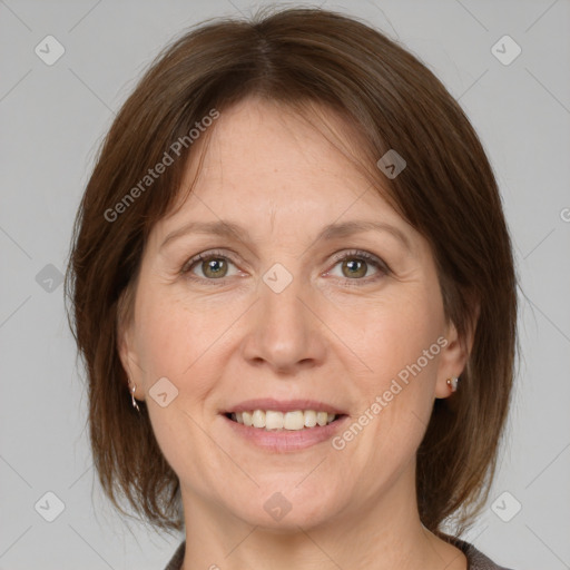 Joyful white adult female with medium  brown hair and grey eyes