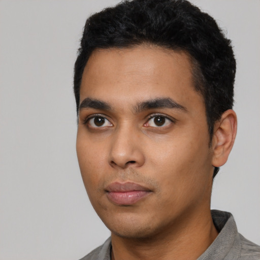 Neutral latino young-adult male with short  black hair and brown eyes
