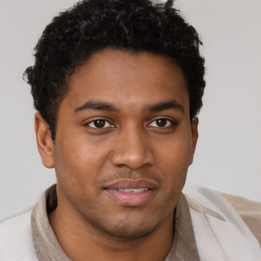 Joyful black young-adult male with short  brown hair and brown eyes