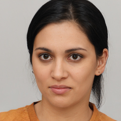 Joyful latino young-adult female with medium  black hair and brown eyes