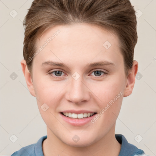 Joyful white young-adult female with short  brown hair and grey eyes