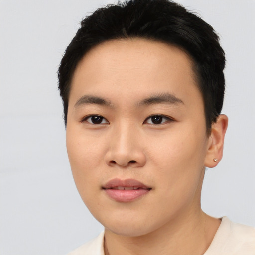 Joyful asian young-adult male with short  black hair and brown eyes