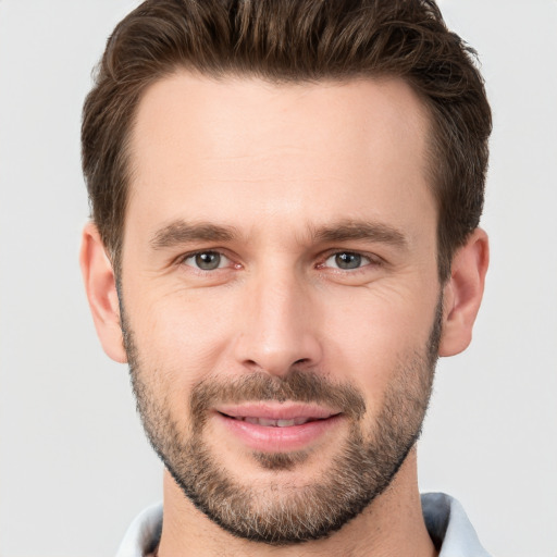 Joyful white young-adult male with short  brown hair and brown eyes