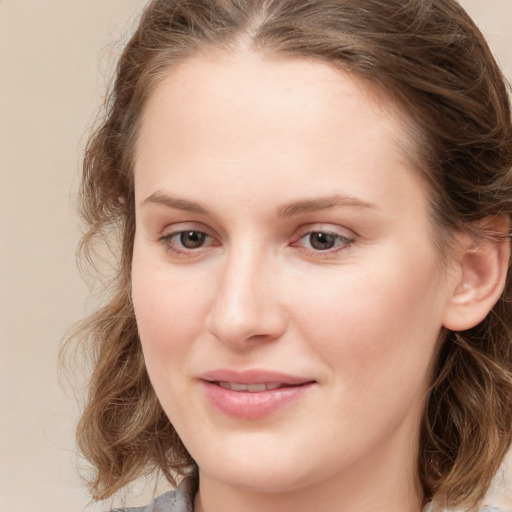 Joyful white young-adult female with medium  brown hair and blue eyes