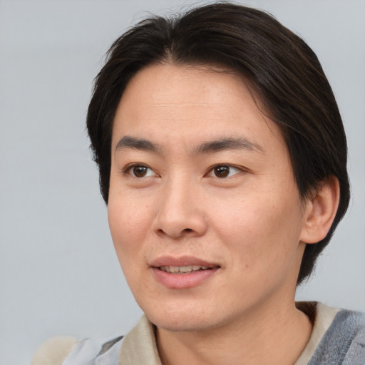Joyful asian young-adult female with short  brown hair and brown eyes