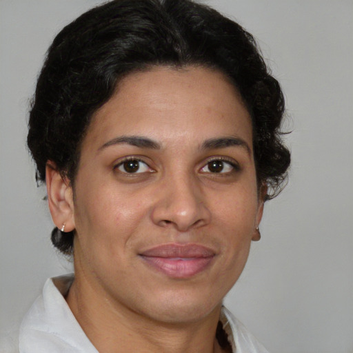 Joyful latino adult female with short  brown hair and brown eyes