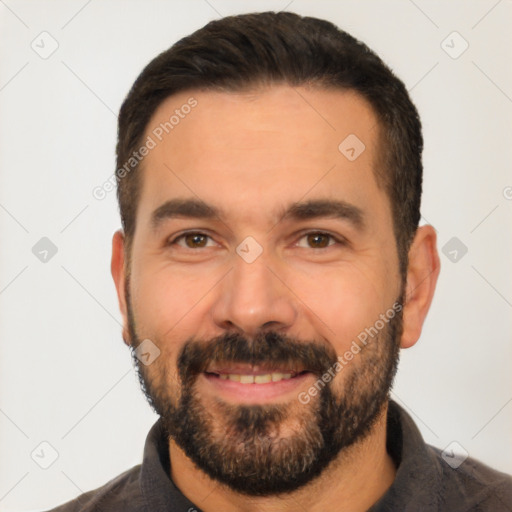 Joyful white adult male with short  black hair and brown eyes