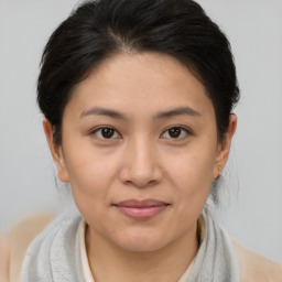 Joyful white young-adult female with medium  brown hair and brown eyes