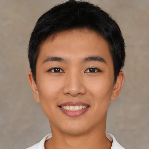 Joyful asian young-adult male with short  brown hair and brown eyes