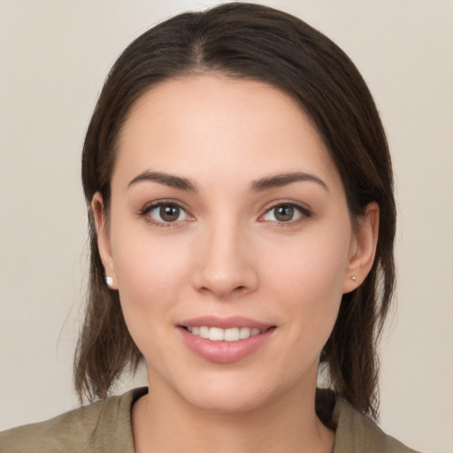 Joyful white young-adult female with medium  brown hair and brown eyes