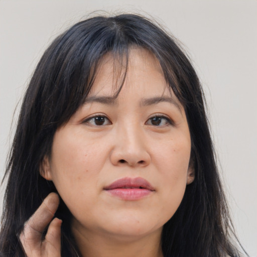 Joyful asian young-adult female with long  brown hair and brown eyes