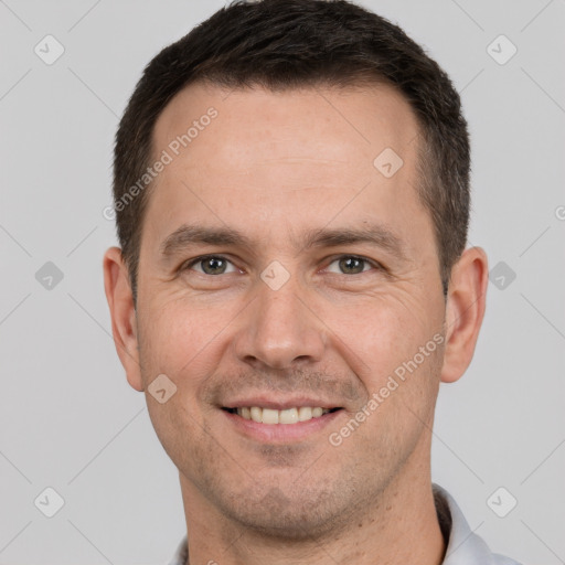 Joyful white adult male with short  brown hair and brown eyes