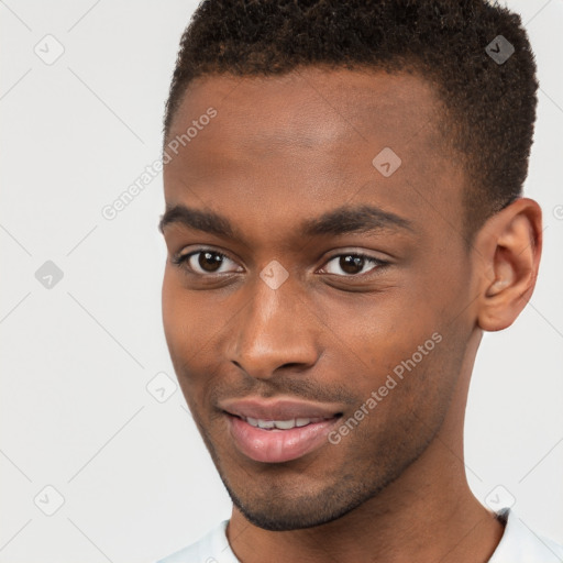 Joyful black young-adult male with short  brown hair and brown eyes