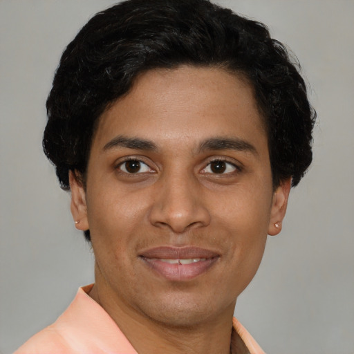 Joyful latino young-adult male with short  brown hair and brown eyes