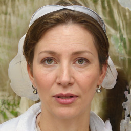 Joyful white adult female with medium  brown hair and brown eyes