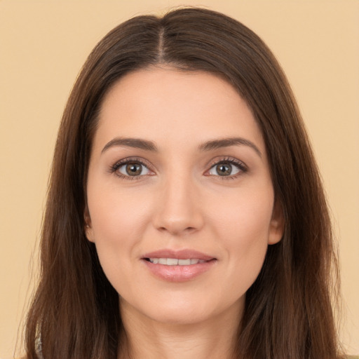 Joyful white young-adult female with long  brown hair and brown eyes